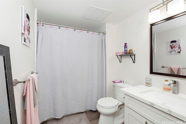 bathroom featuring vanity and toilet