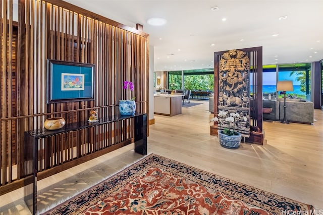 hallway featuring expansive windows and light hardwood / wood-style flooring