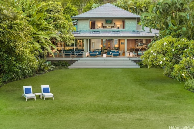 rear view of house featuring a lawn, a patio area, and an outdoor living space