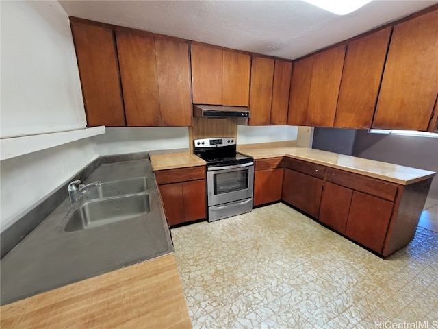 kitchen with stainless steel range with electric cooktop, sink, and a textured ceiling