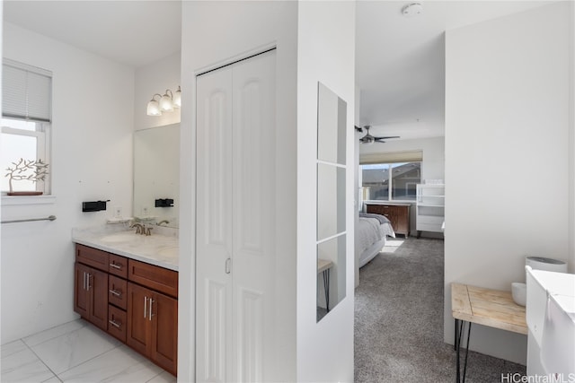 bathroom featuring ceiling fan and vanity