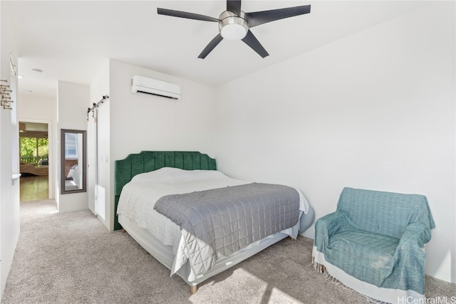 carpeted bedroom featuring an AC wall unit, a barn door, and ceiling fan