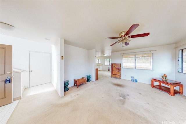 living room featuring light carpet and ceiling fan