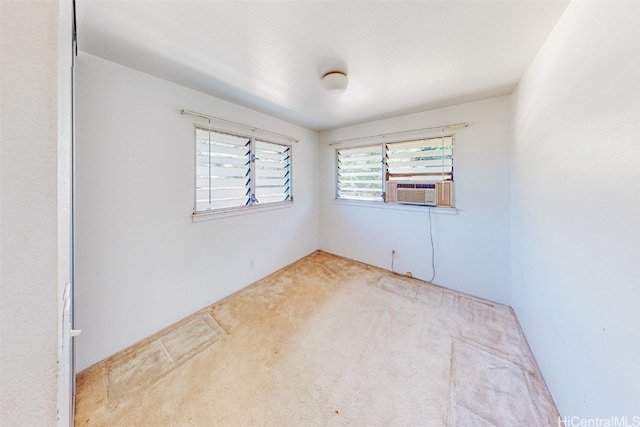 empty room with light colored carpet and cooling unit