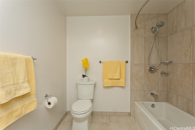 bathroom with tile patterned floors, tiled shower / bath combo, and toilet