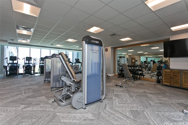 workout area with carpet flooring and a drop ceiling