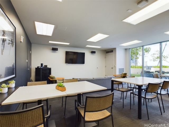 dining room featuring dark carpet