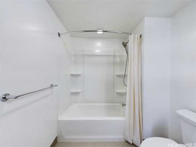 bathroom with tile patterned flooring, toilet, and shower / tub combo