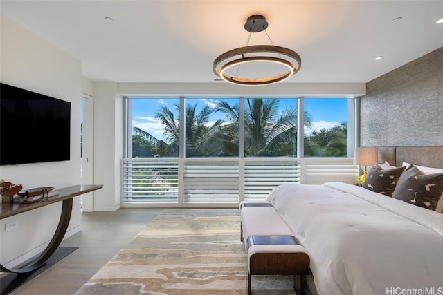 bedroom with hardwood / wood-style floors and multiple windows