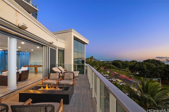 balcony at dusk with a fire pit