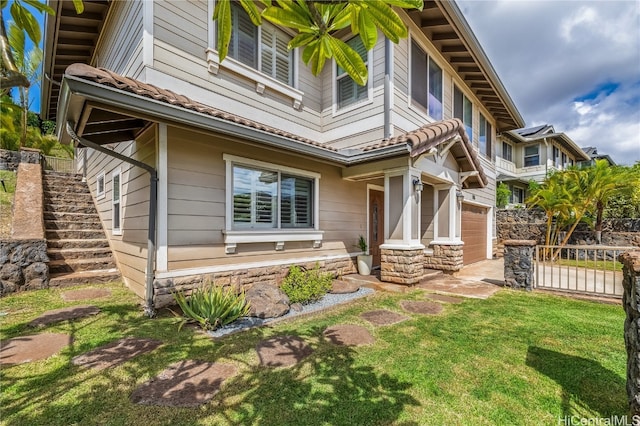 exterior space with a garage and a front lawn