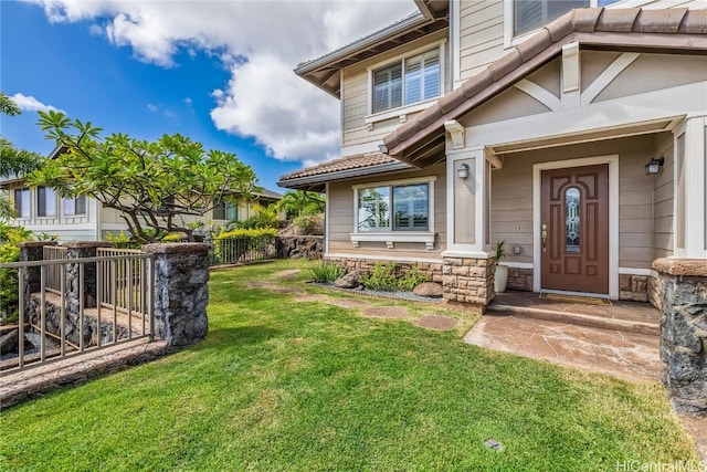 entrance to property featuring a yard