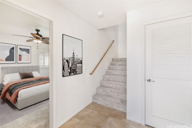 tiled bedroom featuring ceiling fan