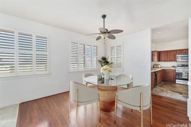 dining space featuring dark hardwood / wood-style flooring and ceiling fan