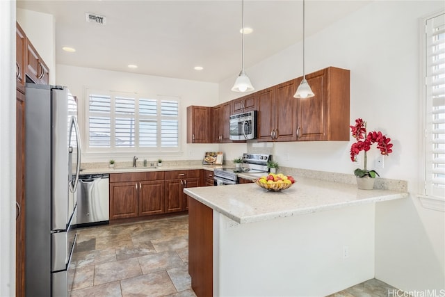 kitchen featuring stainless steel appliances, light stone counters, kitchen peninsula, a wealth of natural light, and decorative light fixtures