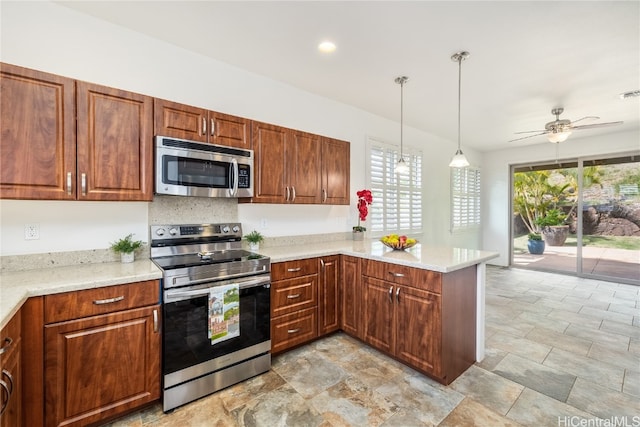 kitchen with stainless steel appliances, kitchen peninsula, hanging light fixtures, ceiling fan, and light stone countertops