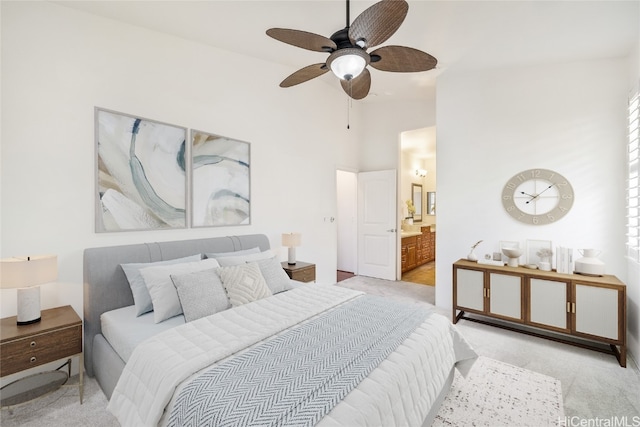 carpeted bedroom with ceiling fan, connected bathroom, and high vaulted ceiling