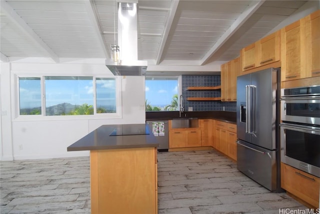 kitchen with island range hood, appliances with stainless steel finishes, light hardwood / wood-style floors, sink, and tasteful backsplash