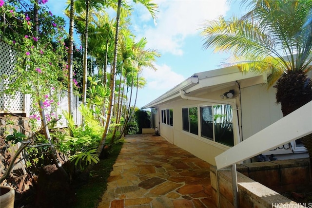 view of property exterior with a patio area