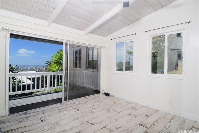 unfurnished sunroom featuring wooden ceiling and vaulted ceiling with beams