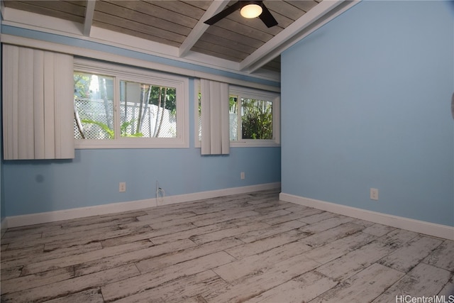 spare room featuring vaulted ceiling with beams, ceiling fan, light hardwood / wood-style floors, and wood ceiling