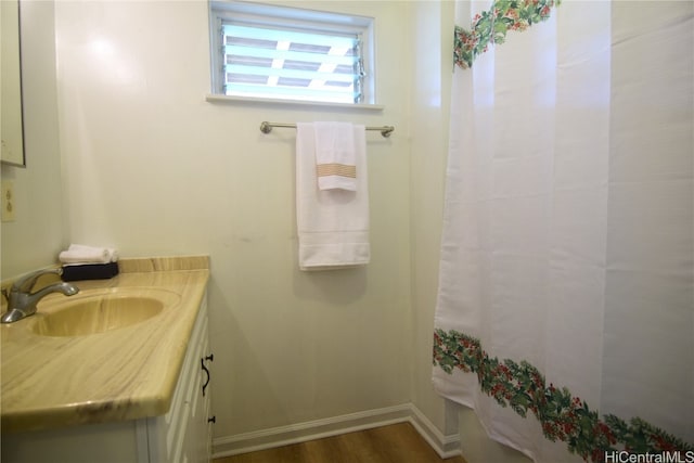 bathroom with vanity and hardwood / wood-style flooring