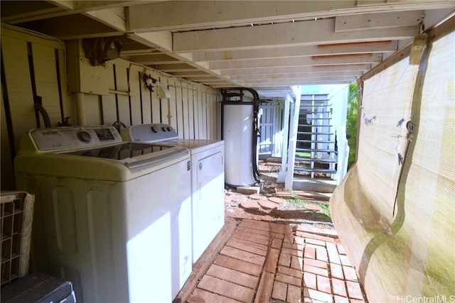 laundry room with independent washer and dryer and gas water heater