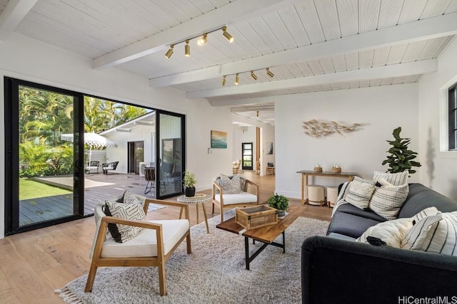 living room with beamed ceiling, light hardwood / wood-style floors, and wooden ceiling