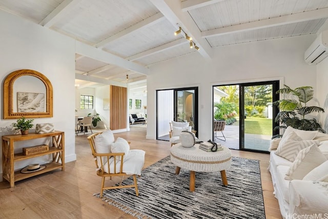 living room featuring french doors, lofted ceiling with beams, a wall mounted AC, track lighting, and light wood-type flooring