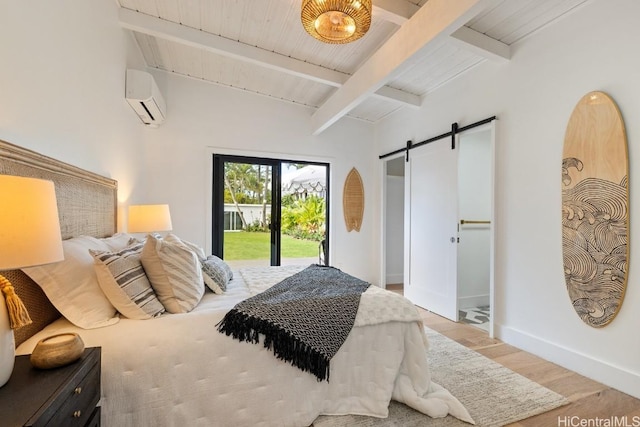 bedroom featuring a barn door, access to exterior, a wall mounted AC, beamed ceiling, and wood-type flooring