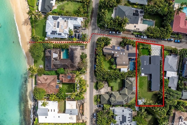 drone / aerial view featuring a water view and a view of the beach