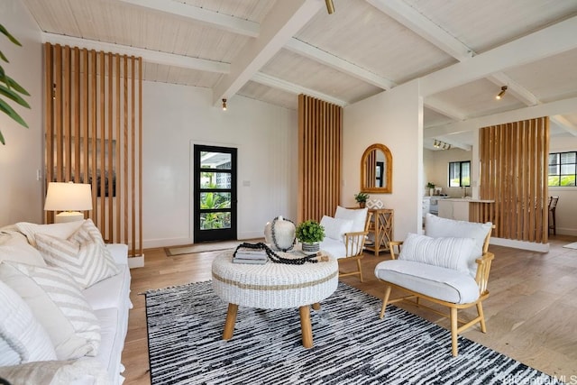 living room with lofted ceiling with beams, light hardwood / wood-style floors, and wooden ceiling