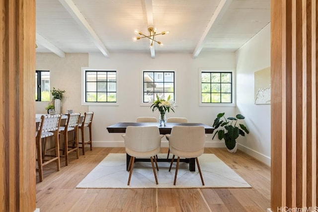 dining area featuring an inviting chandelier, beamed ceiling, and light wood-type flooring