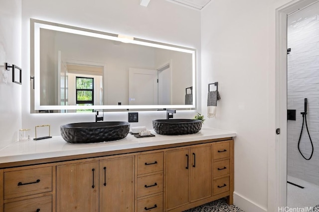 bathroom featuring a tile shower and vanity