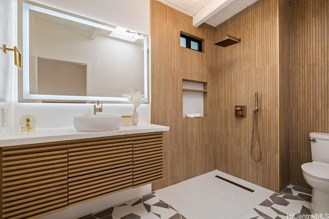 bathroom with tile patterned flooring, beamed ceiling, wood walls, toilet, and vanity