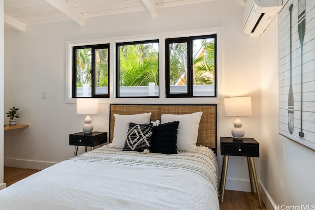 bedroom with multiple windows, a wall mounted AC, beamed ceiling, and dark wood-type flooring