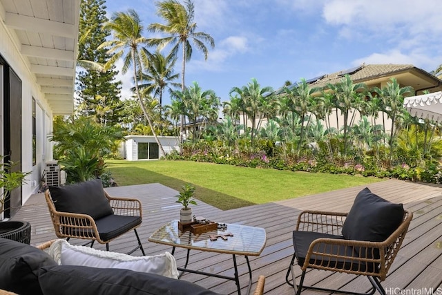 wooden deck with a lawn and outdoor lounge area