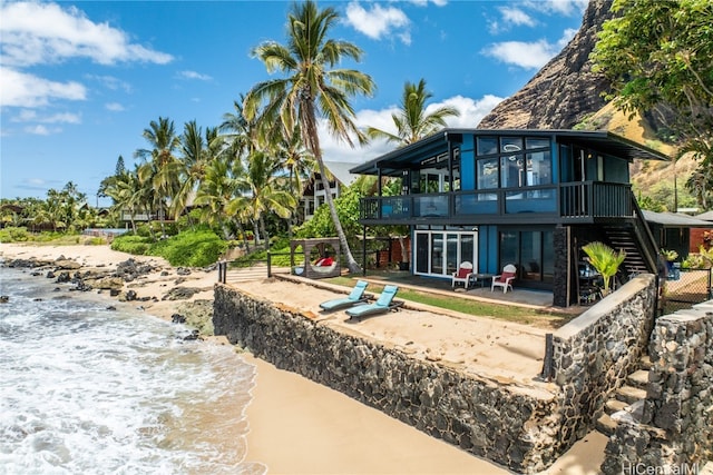 back of property featuring a patio and a water view