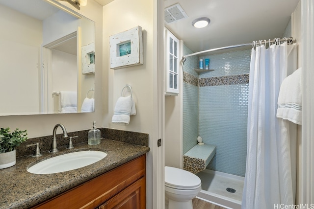 bathroom with a shower with curtain, wood-type flooring, vanity, and toilet