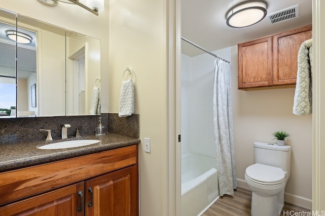 full bathroom featuring toilet, vanity, shower / bath combo with shower curtain, and hardwood / wood-style flooring