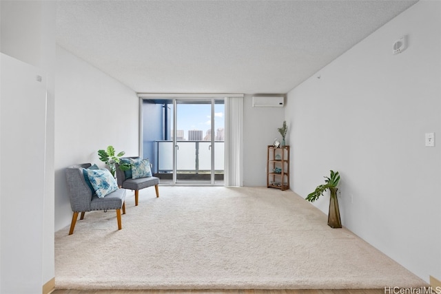 living area with floor to ceiling windows, a textured ceiling, an AC wall unit, and carpet floors