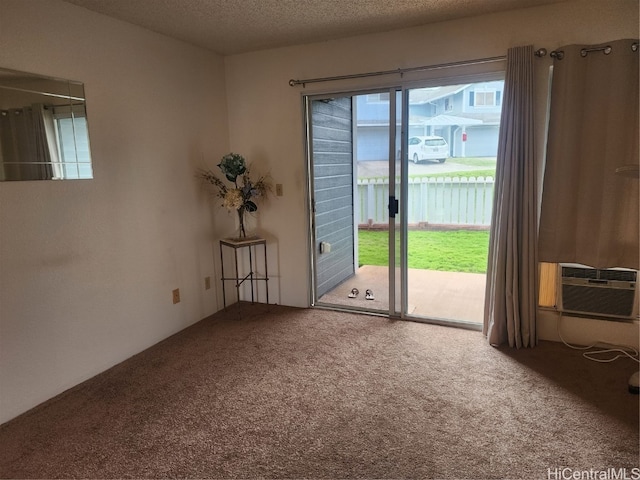 carpeted empty room with a textured ceiling