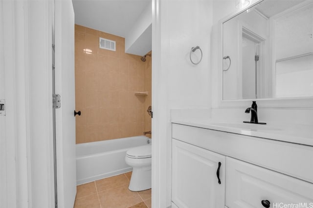 full bathroom featuring toilet, tiled shower / bath combo, vanity, and tile patterned floors