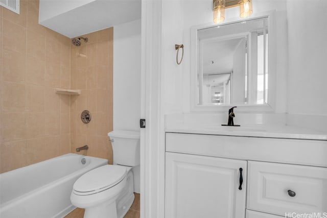 full bathroom featuring toilet, tiled shower / bath combo, vanity, and tile patterned floors