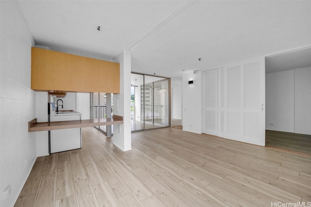 interior space with sink and light wood-type flooring