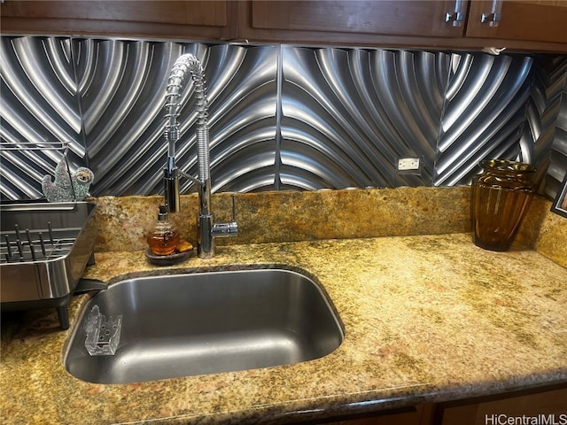 interior details featuring stone counters and sink