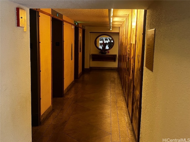 hallway with a textured ceiling