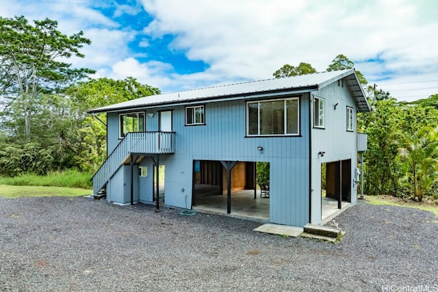 rear view of property featuring a carport