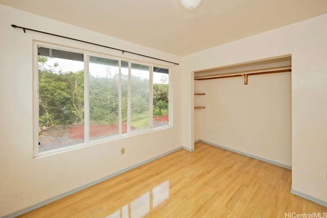 spare room featuring a wealth of natural light and wood-type flooring