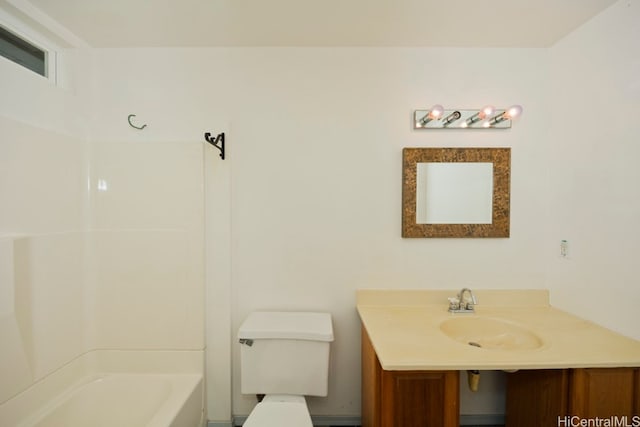 bathroom with a tub to relax in, vanity, and toilet